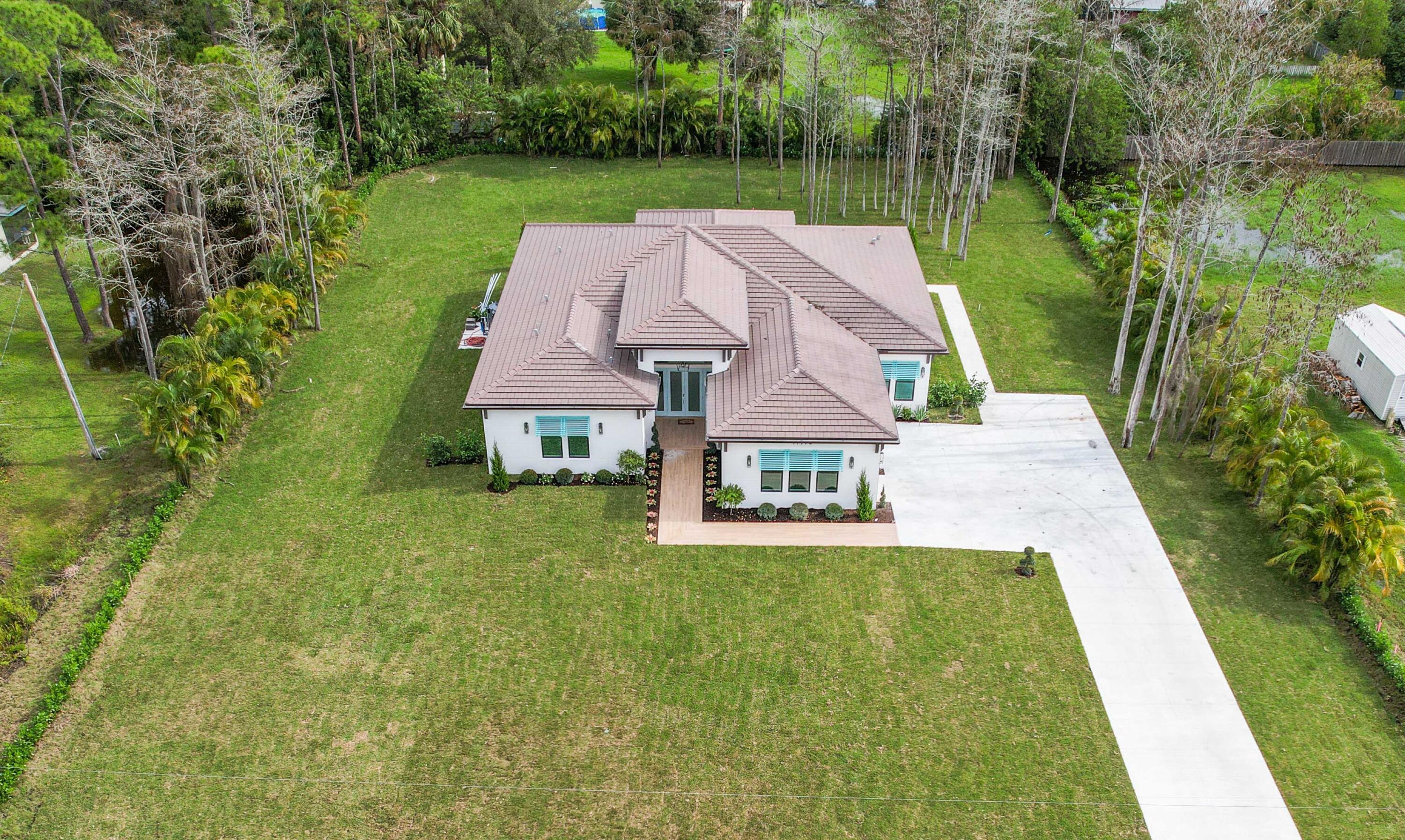 17794 Mellen Lane Jupiter, FL 33478 - Photo 45 of 45 an aerial view of residential houses with outdoor space and trees
