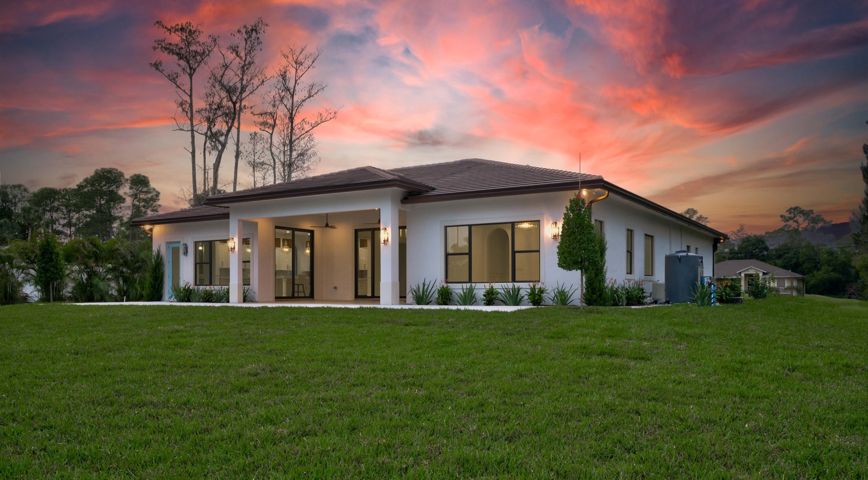 17794 Mellen Lane Jupiter, FL 33478 - Photo 9 of 45 a front view of a house with a yard