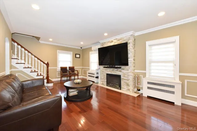 a living room with fireplace furniture and a flat screen tv