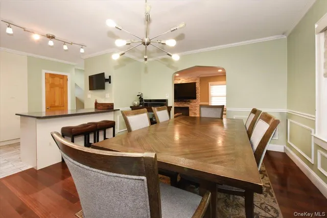 a kitchen with a table chairs and a chandelier