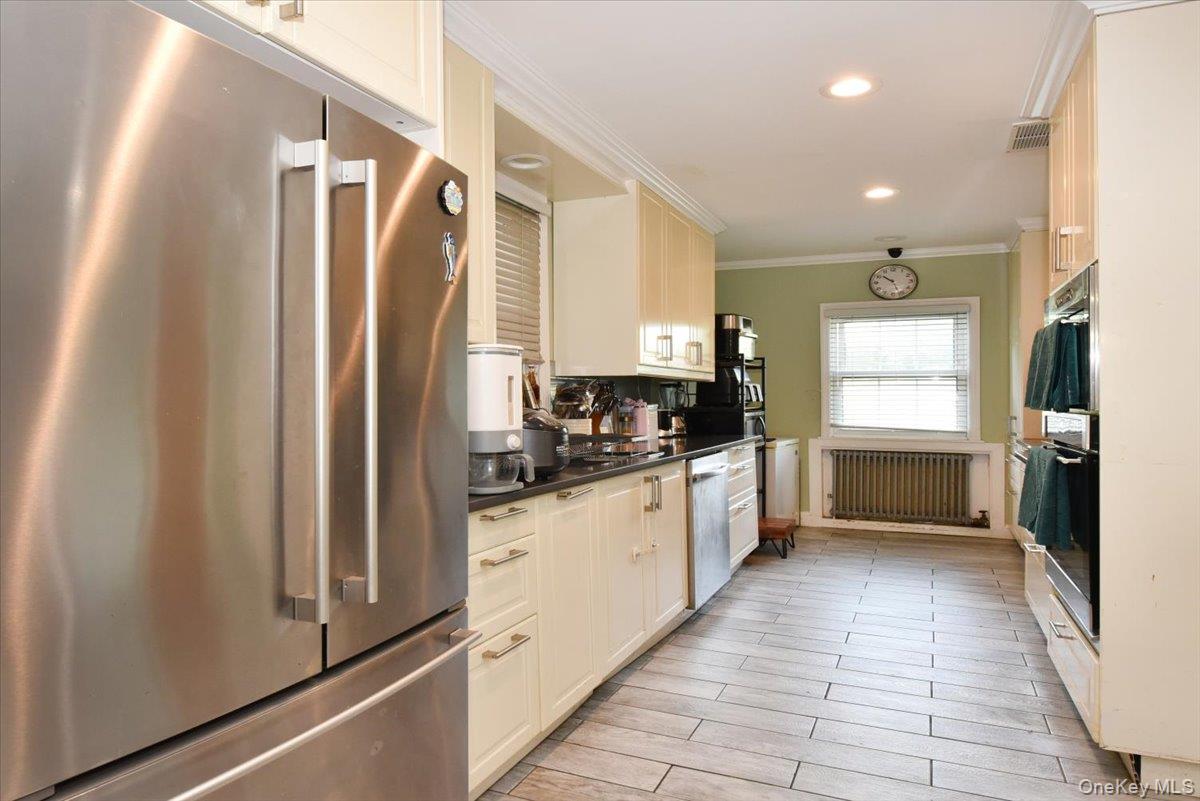 193-46 McLaughlin Avenue Queens, NY 11423 - Photo 17 of 34 a kitchen with granite countertop a refrigerator and a sink