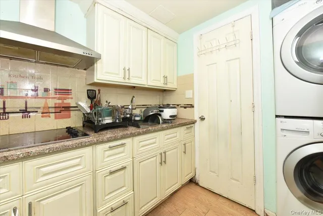a kitchen with granite countertop white cabinets and a sink