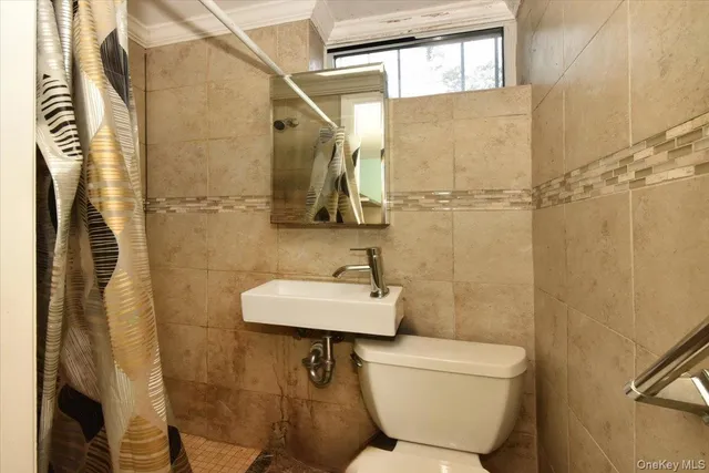 a bathroom with a toilet sink and shower