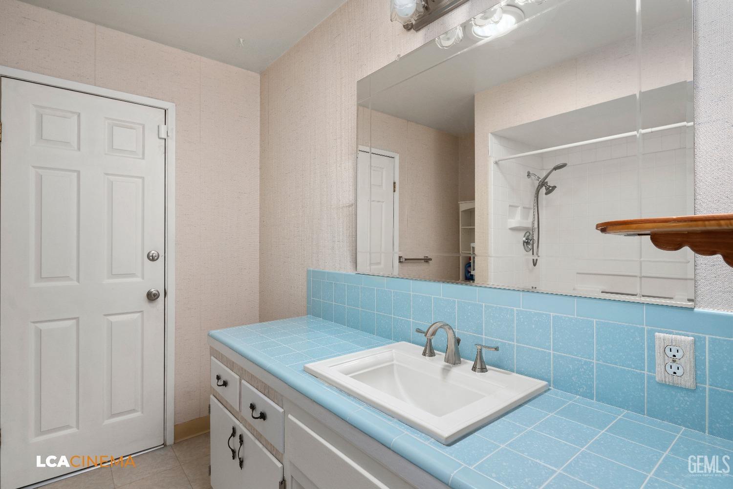 Undisclosed Address Bakersfield, CA 93306 - Photo 11 of 20 a bathroom with a sink and a mirror