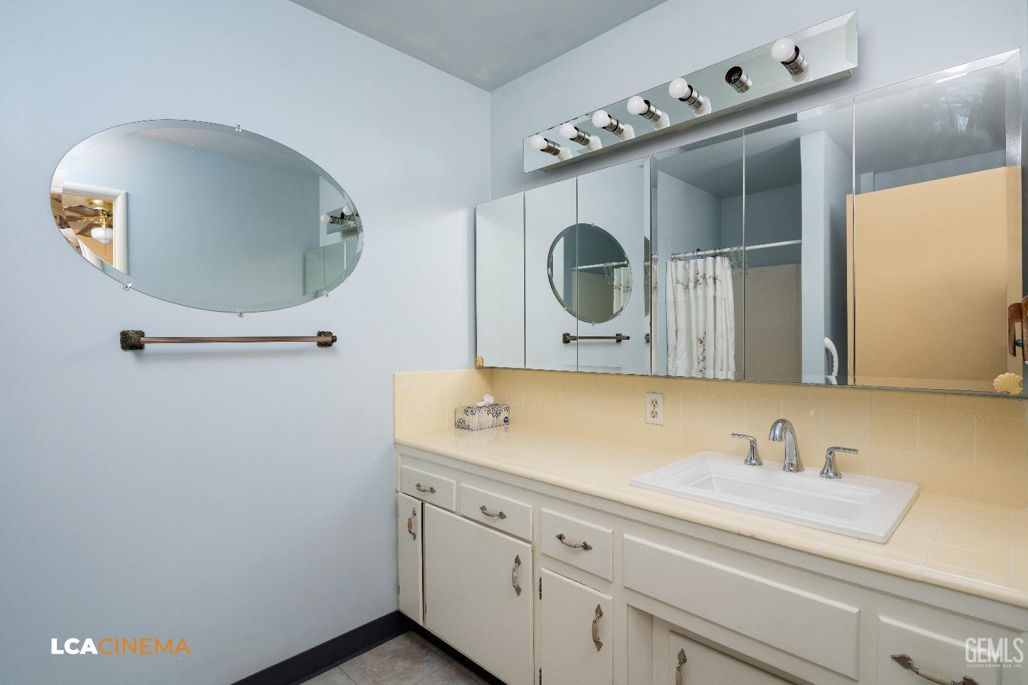 Undisclosed Address Bakersfield, CA 93306 - Photo 16 of 20 a bathroom with a sink and a mirror
