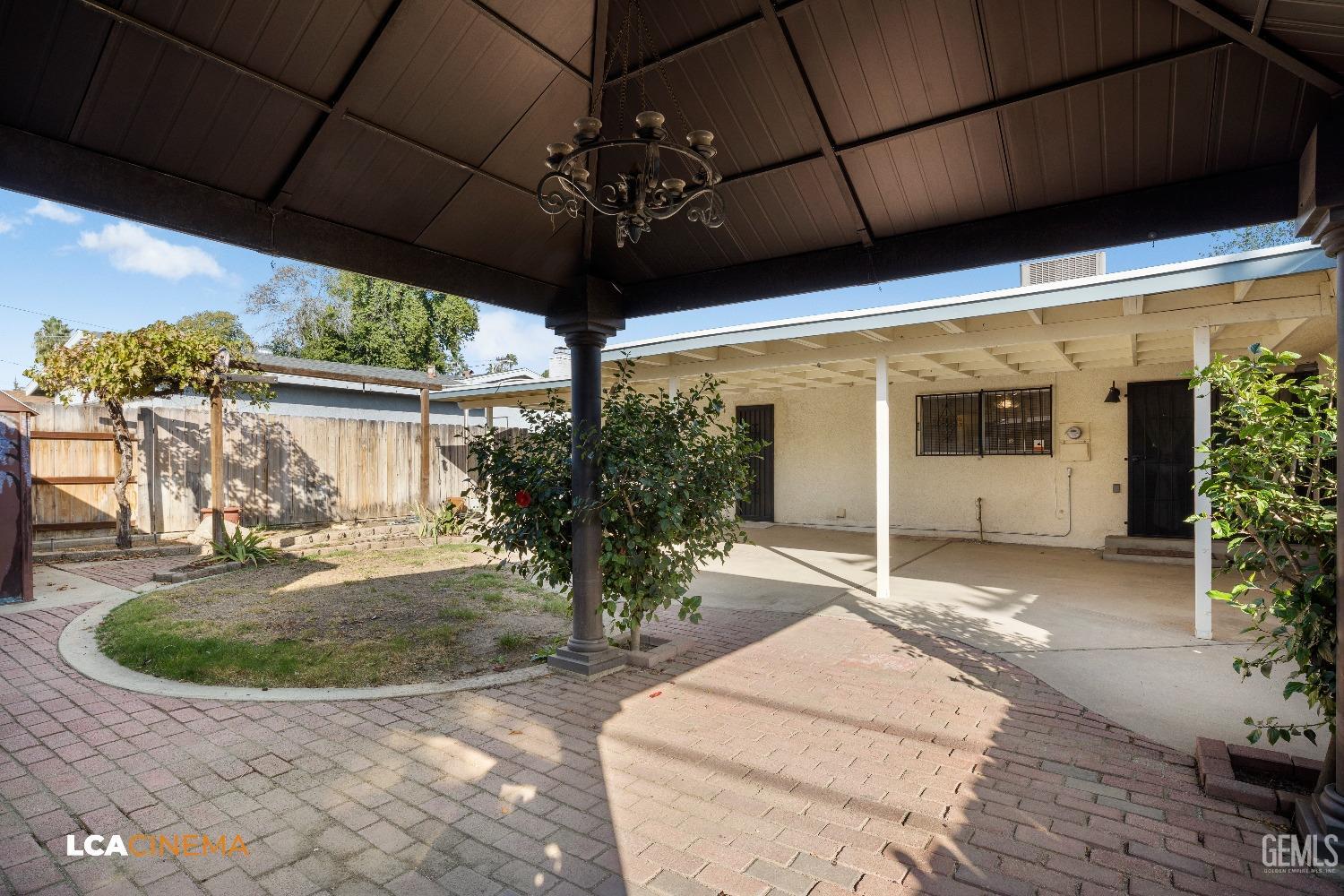 Undisclosed Address Bakersfield, CA 93306 - Photo 18 of 20 a view of a porch with a table and chairs under an umbrella