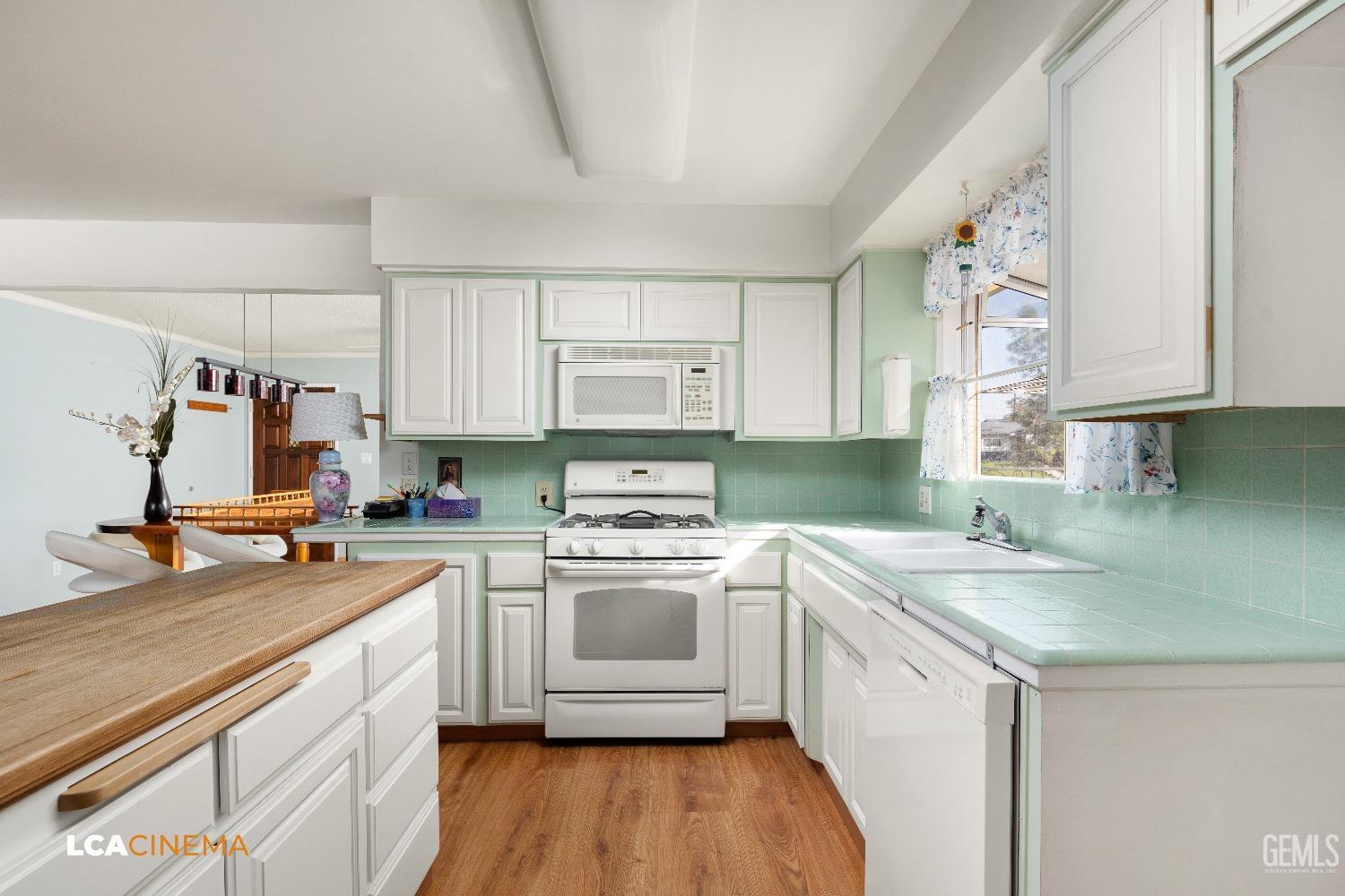 Undisclosed Address Bakersfield, CA 93306 - Photo 9 of 20 a kitchen with a sink stove and cabinets