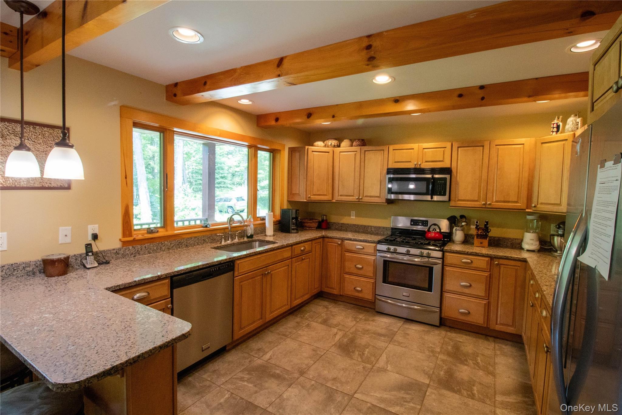 384 Morton Hill Road Roscoe, NY 12776 - Photo 11 of 27 Kitchen featuring light stone countertops, appliances with stainless steel finishes, pendant lighting, beamed ceiling, and recessed lighting