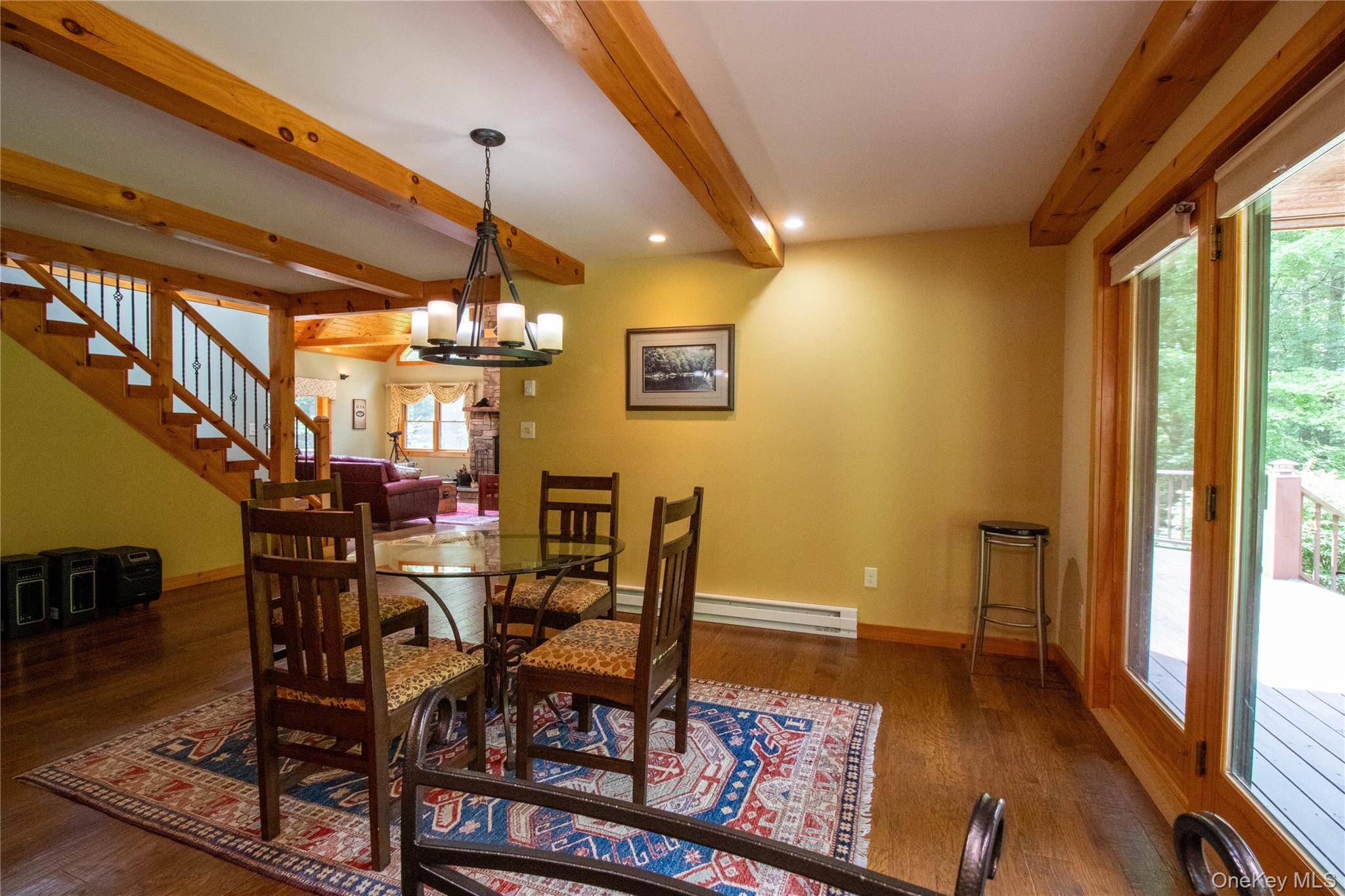 384 Morton Hill Road Roscoe, NY 12776 - Photo 13 of 27 Dining space with a chandelier, dark wood-style flooring, stairs, beamed ceiling, and a baseboard heating unit