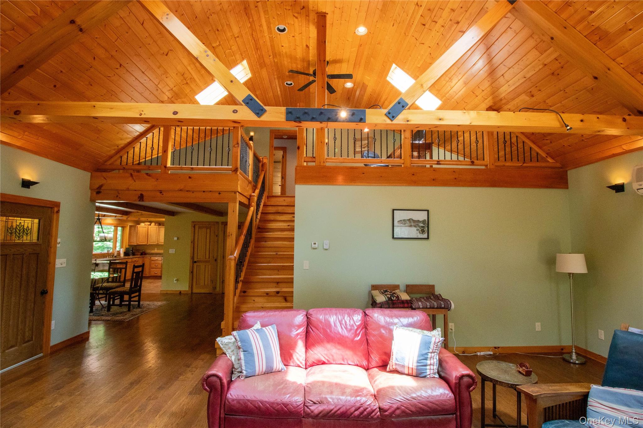 384 Morton Hill Road Roscoe, NY 12776 - Photo 15 of 27 Living room with a ceiling fan, a wood ceiling with exposed beams, wood finished floors, stairs, and high vaulted ceiling