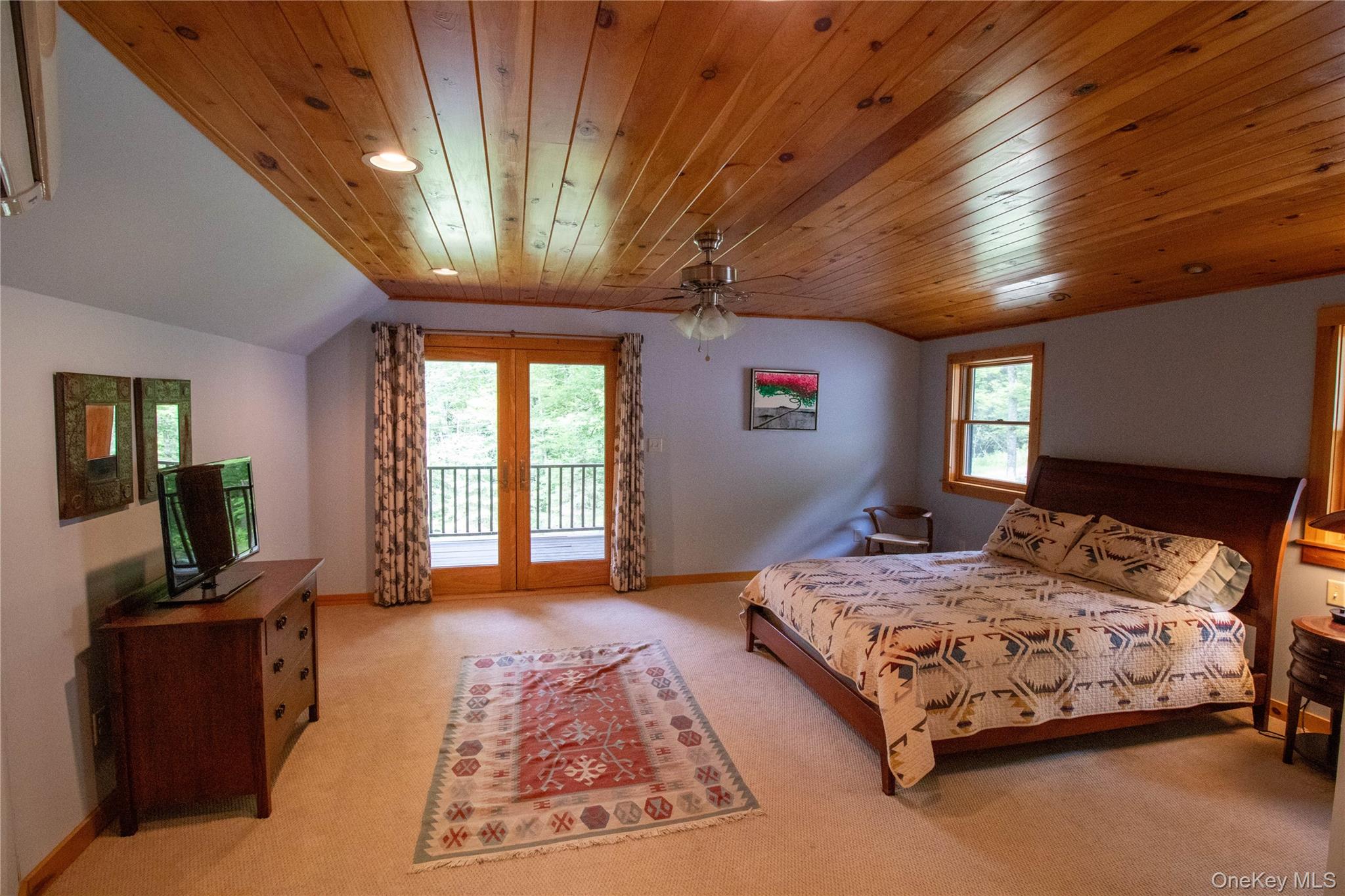 384 Morton Hill Road Roscoe, NY 12776 - Photo 16 of 27 Bedroom featuring access to exterior, light colored carpet, lofted ceiling, wood ceiling, and ceiling fan