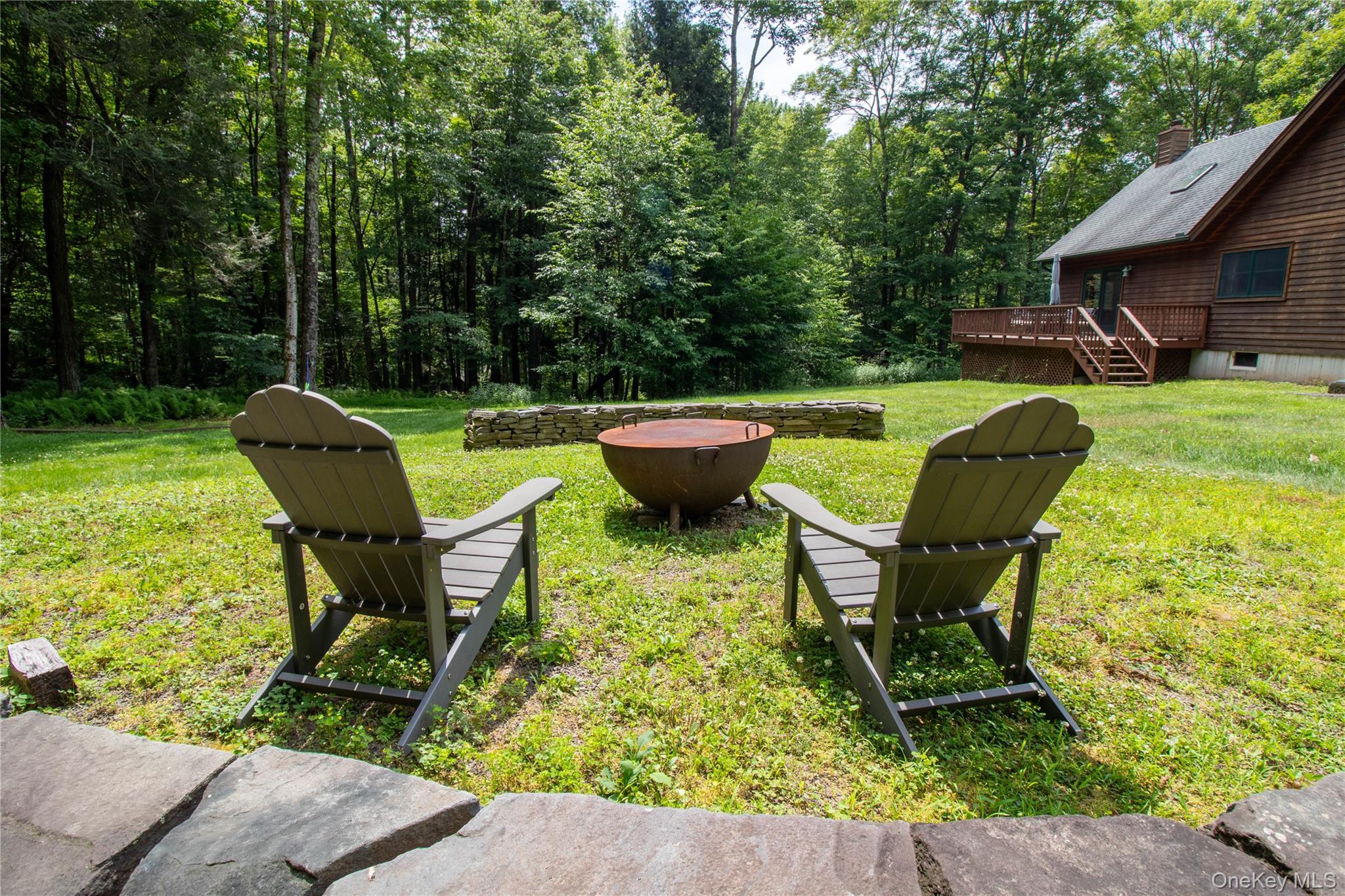 384 Morton Hill Road Roscoe, NY 12776 - Photo 4 of 27 View of grassy yard featuring an outdoor fire pit, a wooden deck, and stairway