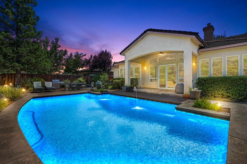 a view of a house with swimming pool yard and outdoor seating