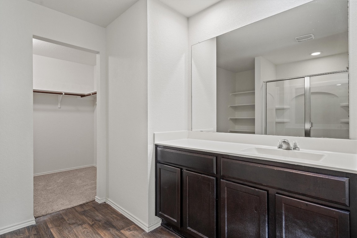 11908 Pyrite Road Manor, TX 78653 - Photo 22 of 35 a bathroom with a sink and a mirror