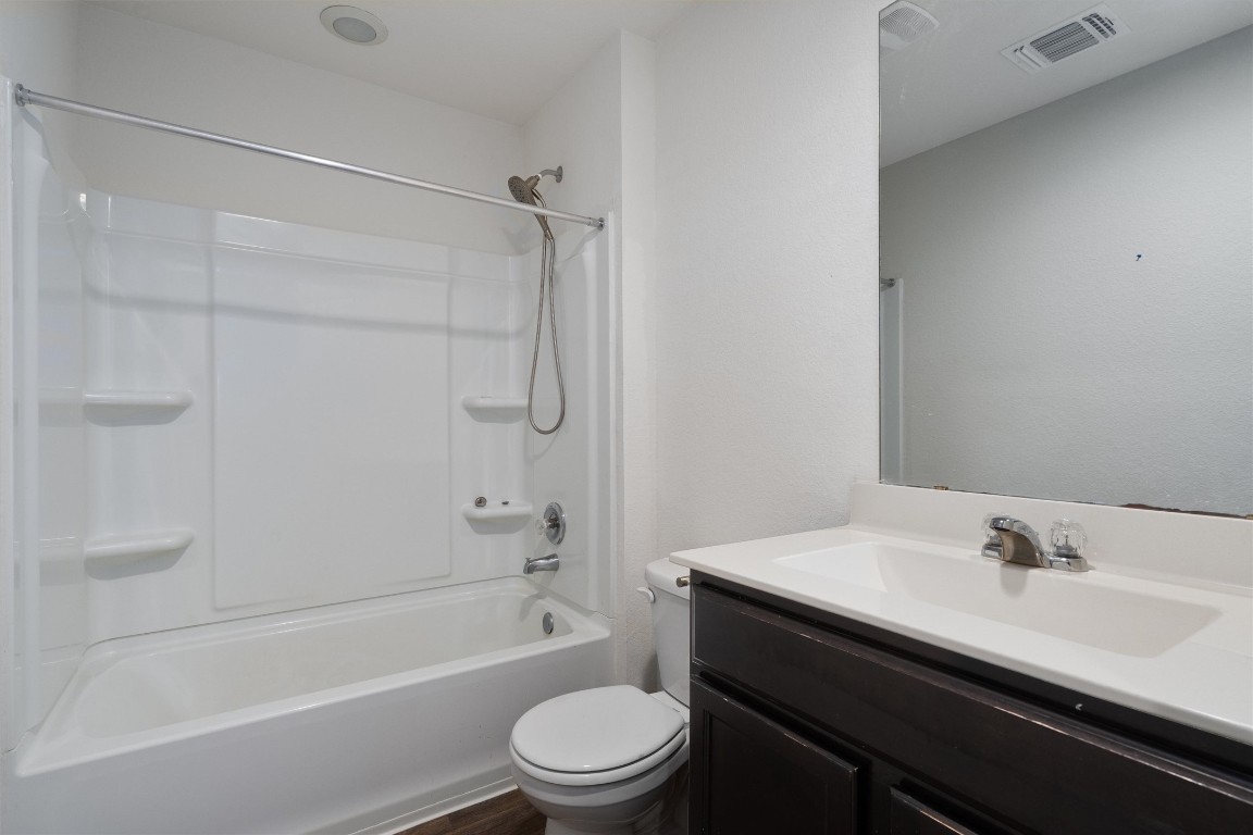 11908 Pyrite Road Manor, TX 78653 - Photo 32 of 35 a bathroom with a sink a toilet and a bathtub