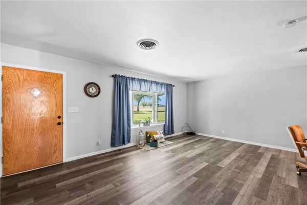 a view of a dining room with furniture wooden floor and chandelier
