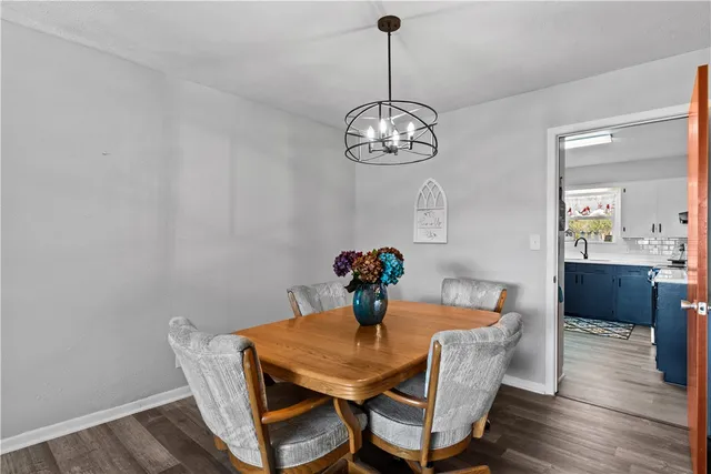 a view of a dining room with furniture wooden floor and chandelier