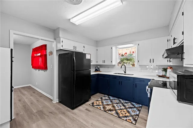 a kitchen with stainless steel appliances granite countertop a refrigerator and a sink