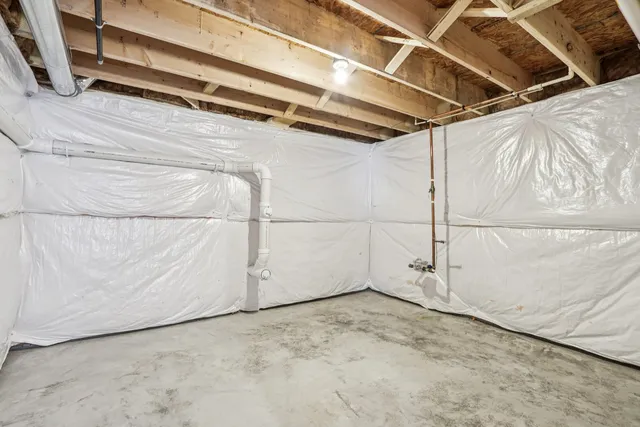 a kitchen with a table chairs refrigerator and microwave