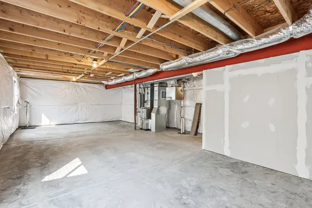 a kitchen with a refrigerator a stove and white cabinets