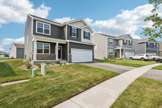 a bedroom with a bed and a lamp on dresser