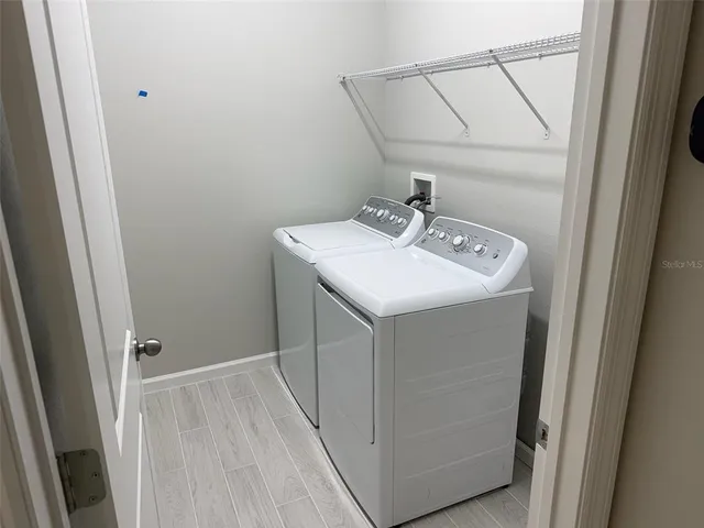 a utility room with a sink washer and dryer