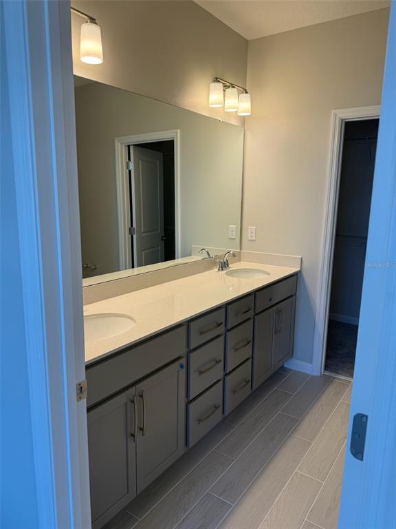 619 Pothos Street Apopka, FL 32703 - Photo 23 of 37 a bathroom with a double vanity sink and mirror