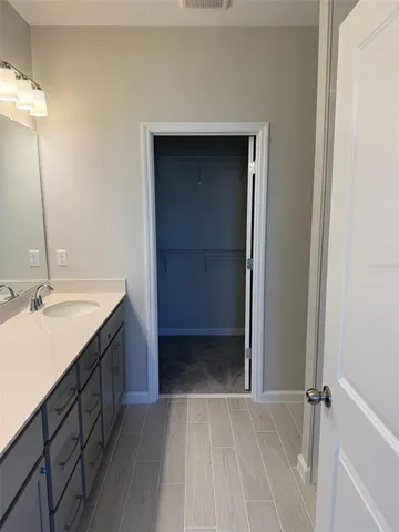 a white toilet sitting in a bathroom next to a sink