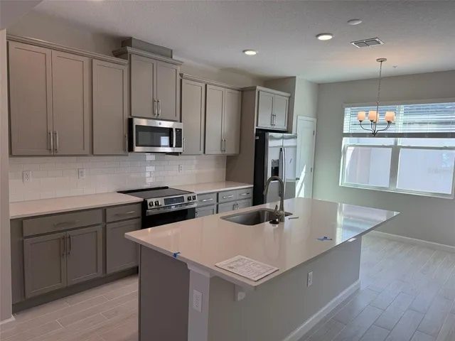 a kitchen that has a sink and a stove in it