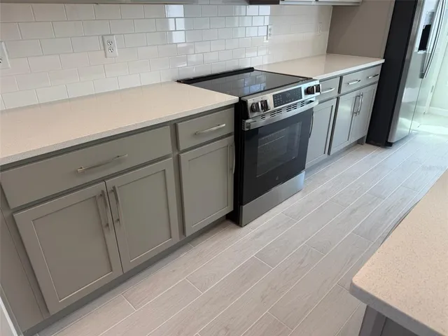 a kitchen with granite countertop white cabinets and white appliances