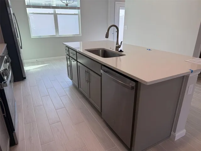a kitchen with a sink and washing machine