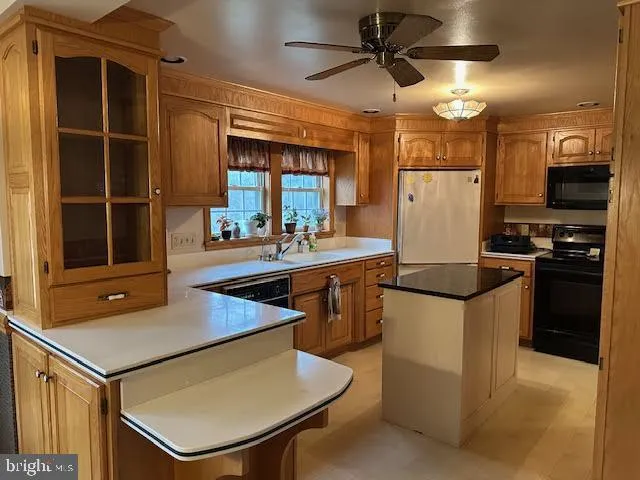 a kitchen with stainless steel appliances a refrigerator a stove a sink and a microwave