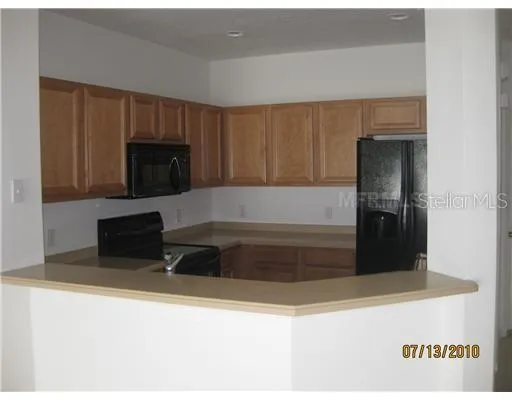 a kitchen with a refrigerator and a stove