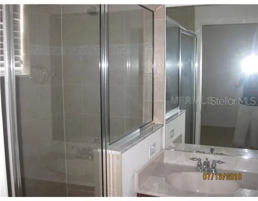 a bathroom with a shower and a sink