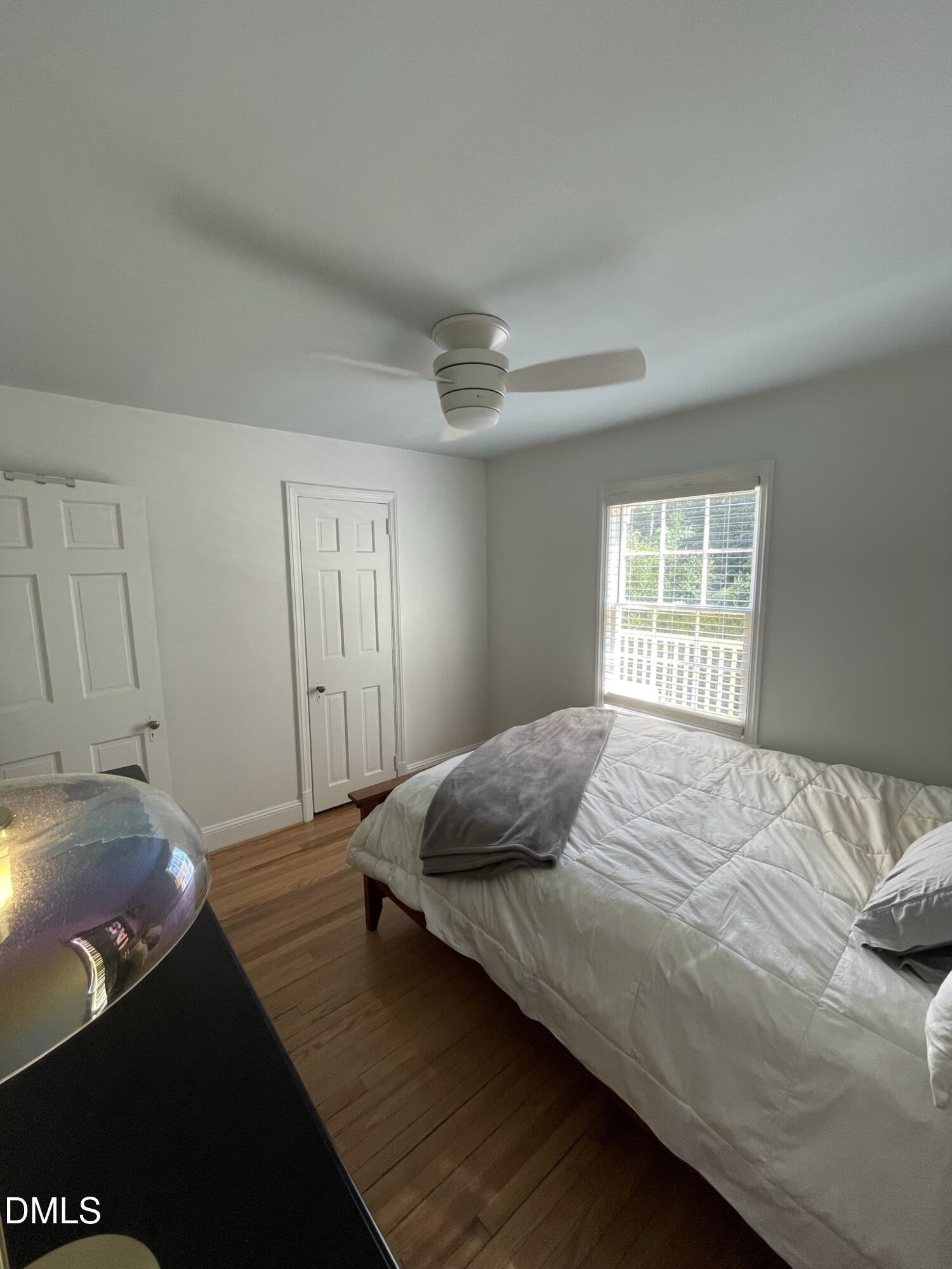 1009 Canterbury Road Raleigh, NC 27607 - Photo 9 of 31 a bedroom with a bed and wooden floor