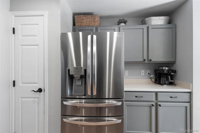 a bathroom with a granite countertop toilet a sink and a mirror