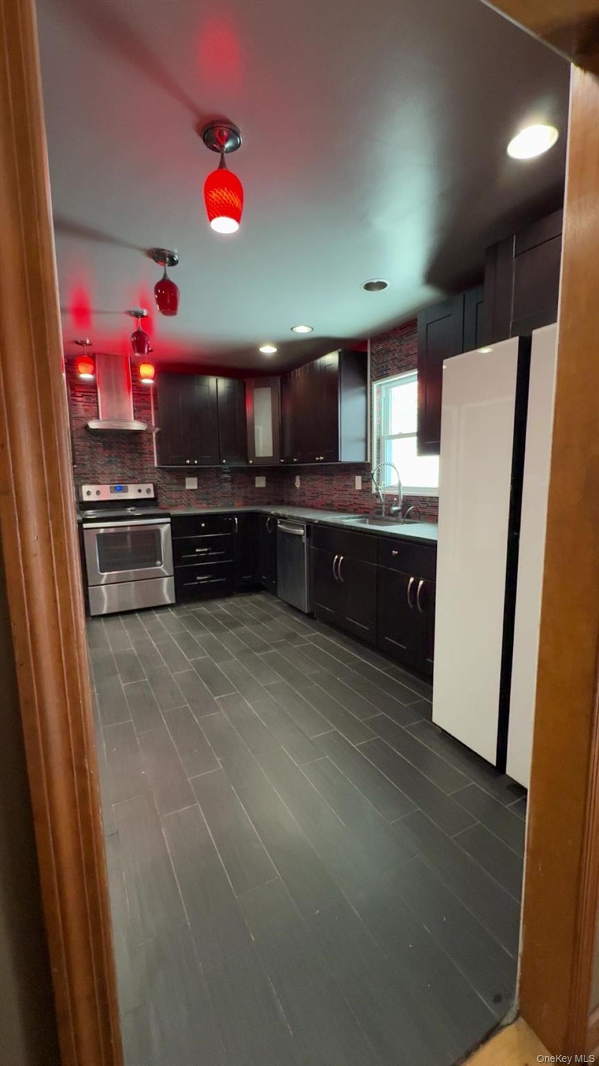 93 Old Mill Road Wallkill, NY 12589 - Photo 13 of 39 Kitchen featuring stainless steel appliances, island exhaust hood, decorative backsplash, recessed lighting, and dark brown cabinetry
