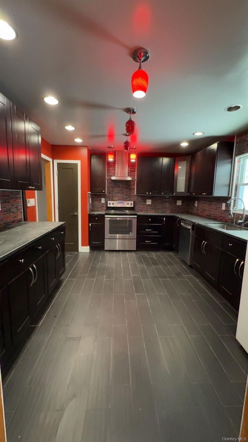 93 Old Mill Road Wallkill, NY 12589 - Photo 14 of 39 Kitchen featuring stainless steel appliances, ventilation hood, recessed lighting, backsplash, and dark brown cabinetry