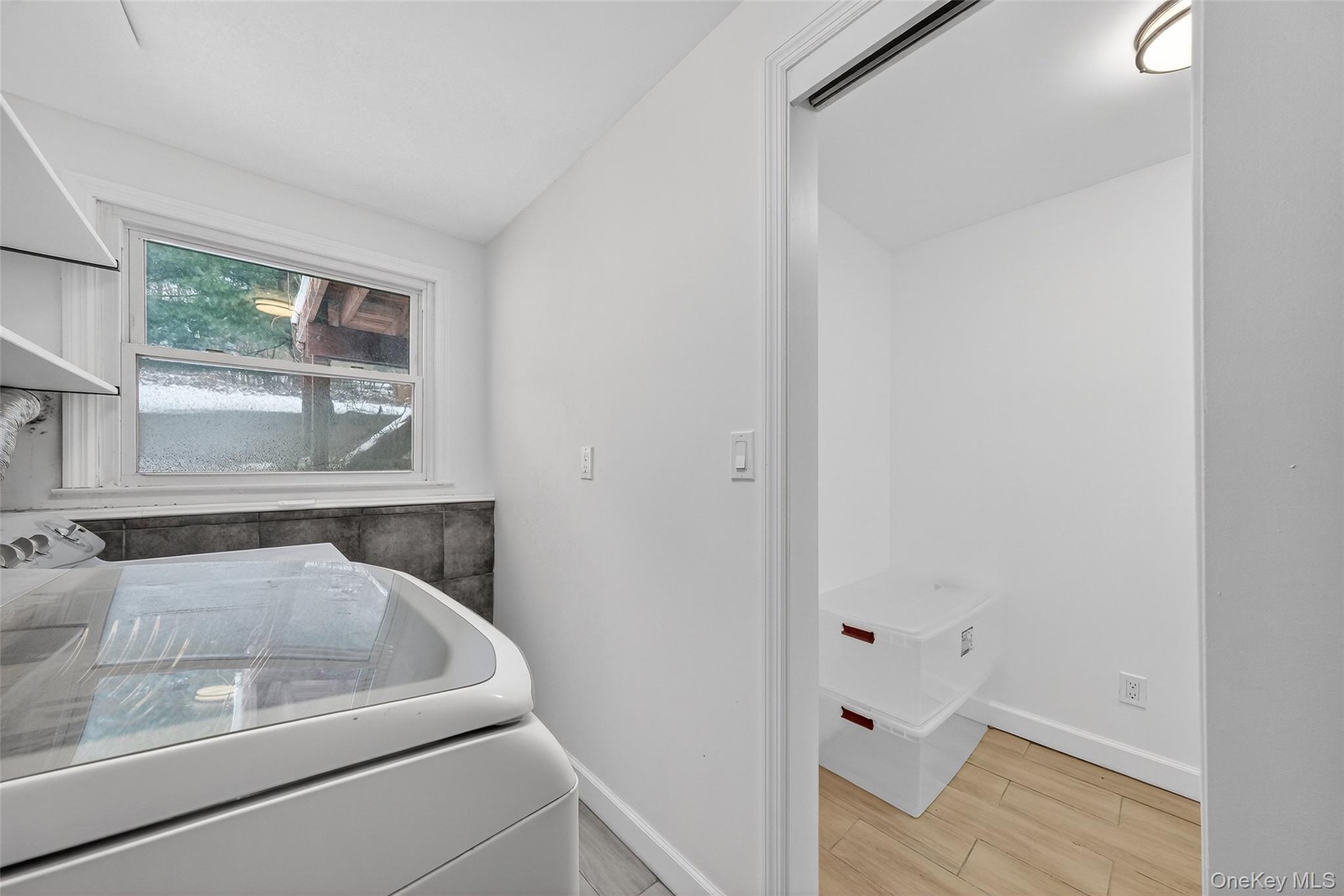 93 Old Mill Road Wallkill, NY 12589 - Photo 30 of 39 Laundry area with washer / dryer and wood tiled floors