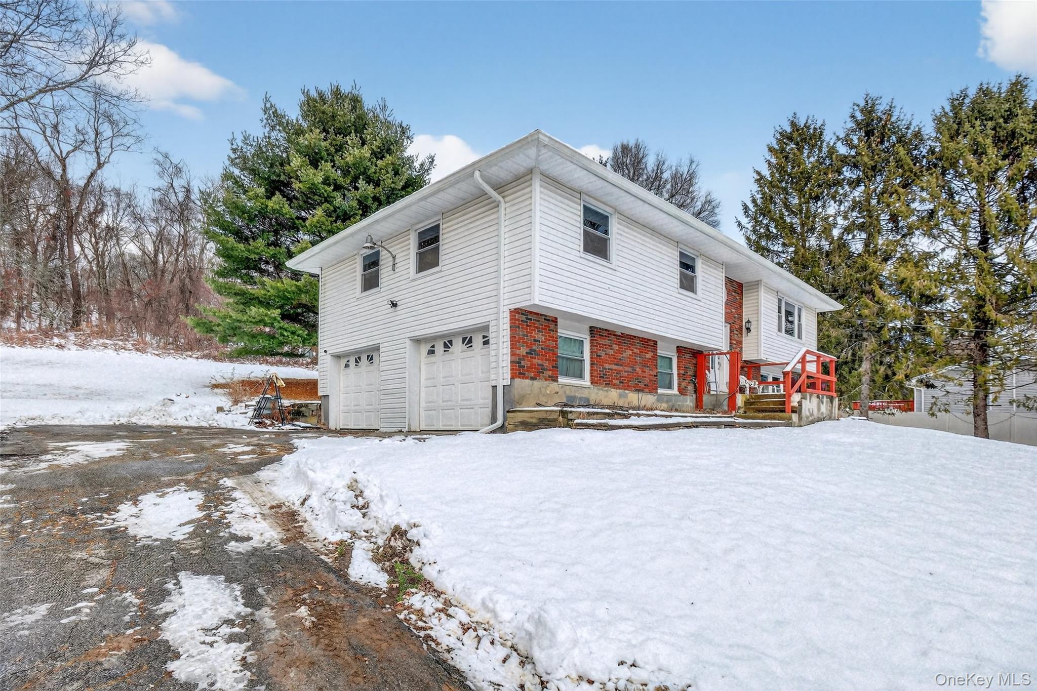 93 Old Mill Road Wallkill, NY 12589 - Photo 3 of 39 Snow covered property with a garage and brick siding