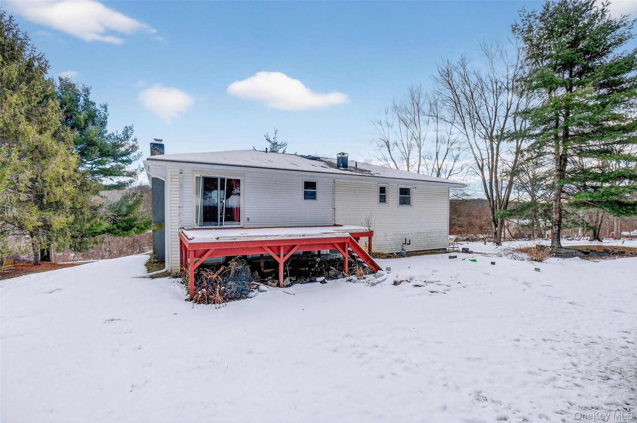 93 Old Mill Road Wallkill, NY 12589 - Photo 35 of 39 Snow covered rear of property with a chimney and a wooden deck