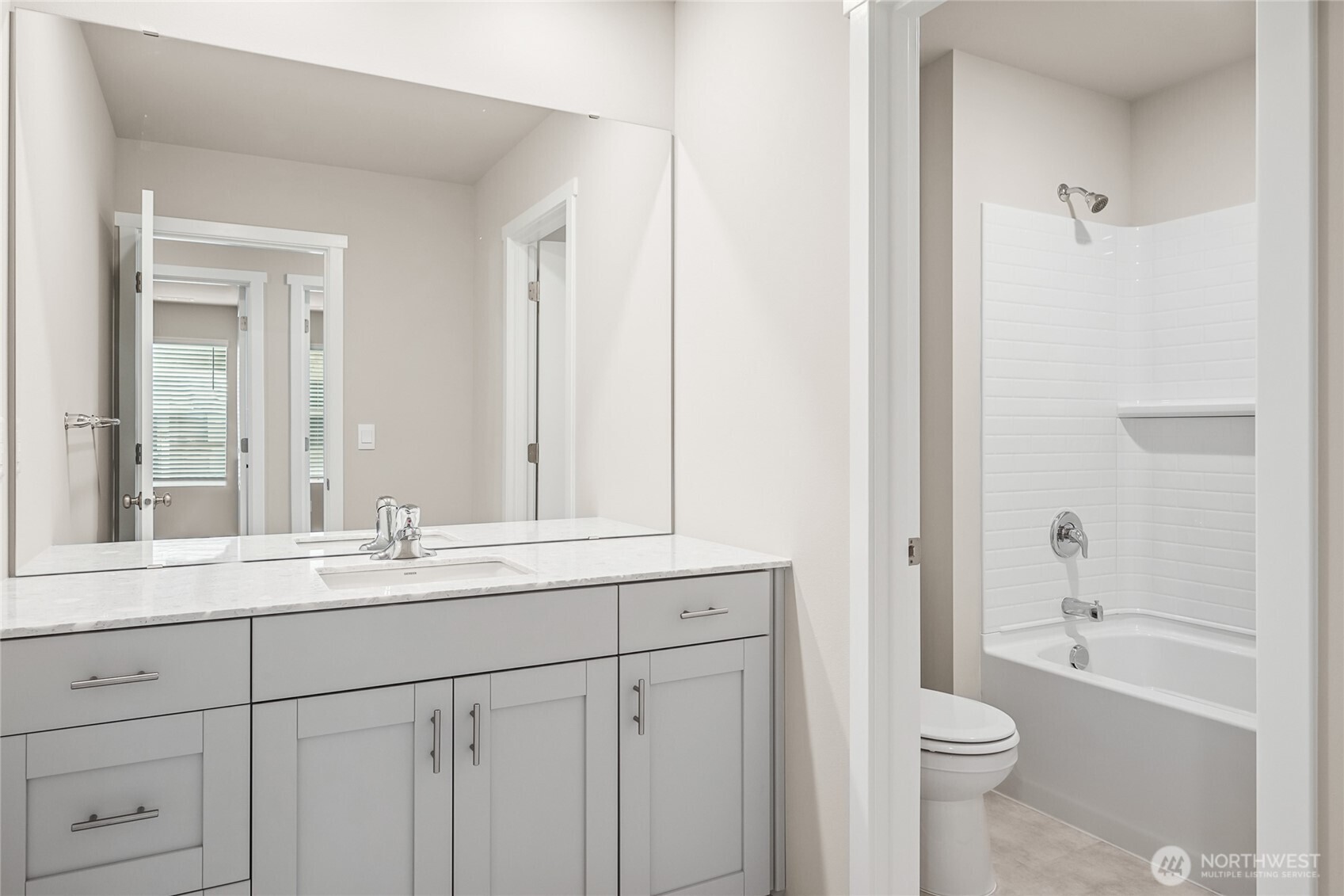 5801 Ivanoff Lane Southwest, Unit 68 Port Orchard, WA 98367 - Photo 17 of 25 a bathroom with a sink a toilet and a mirror