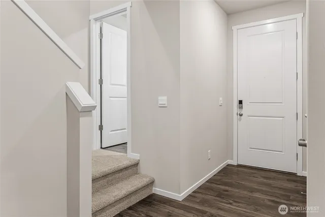 a view of entryway and hall with wooden floor