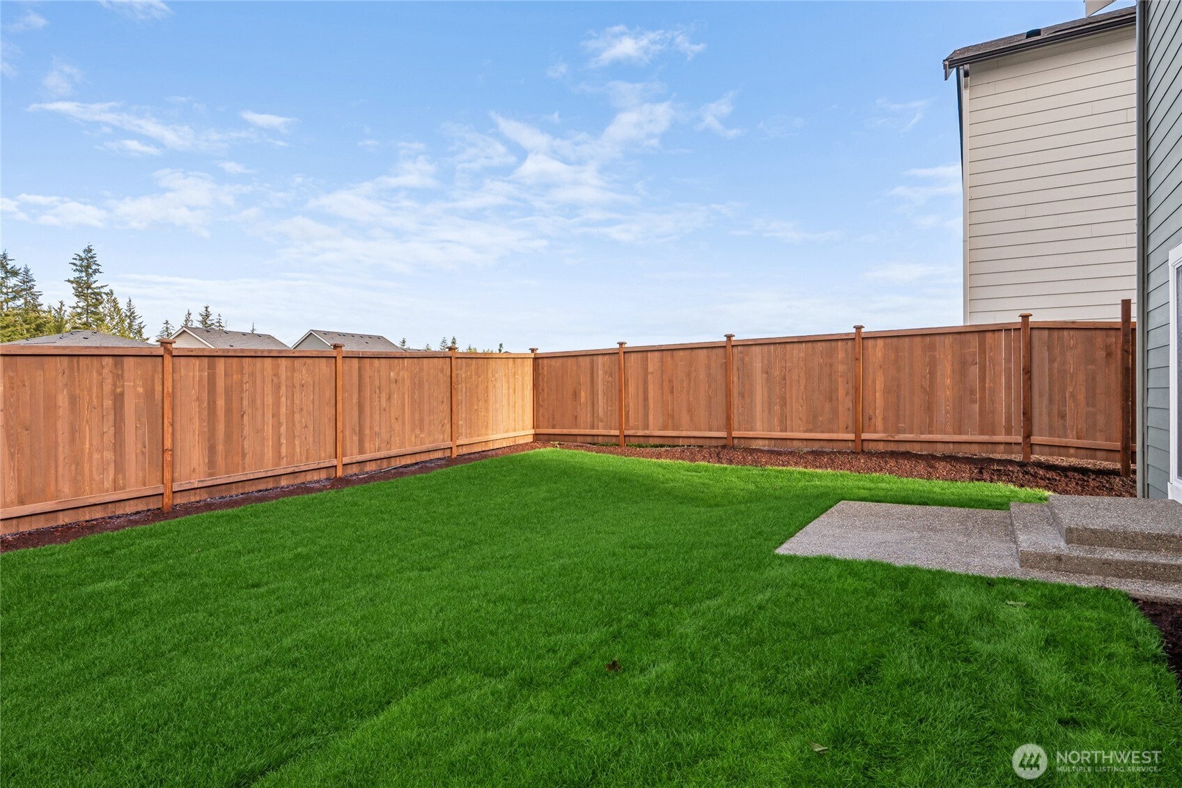 5801 Ivanoff Lane Southwest, Unit 68 Port Orchard, WA 98367 - Photo 23 of 25 a view of a backyard with potted plants and wooden fence