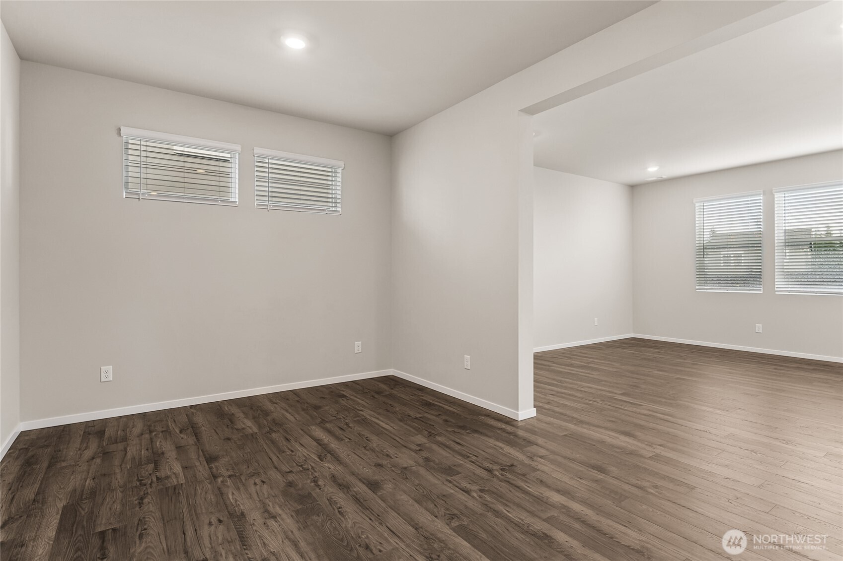 5801 Ivanoff Lane Southwest, Unit 68 Port Orchard, WA 98367 - Photo 3 of 25 a view of an empty room with wooden floor and a window