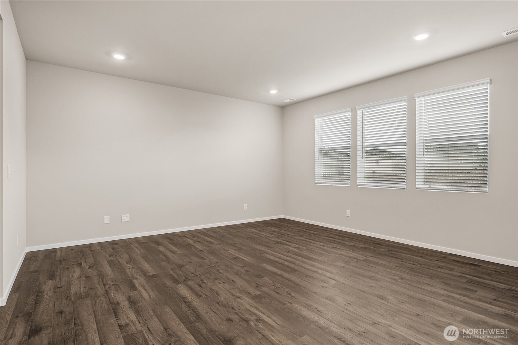 5801 Ivanoff Lane Southwest, Unit 68 Port Orchard, WA 98367 - Photo 5 of 25 a view of empty room with wooden floor and fan