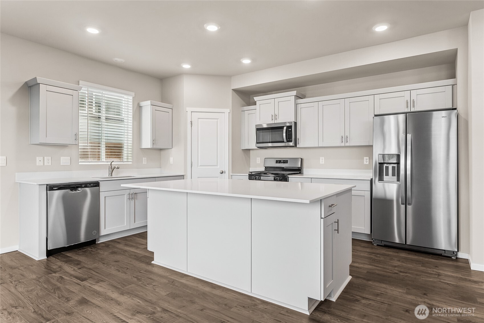 5801 Ivanoff Lane Southwest, Unit 68 Port Orchard, WA 98367 - Photo 8 of 25 a kitchen with stainless steel appliances a refrigerator stove microwave and sink