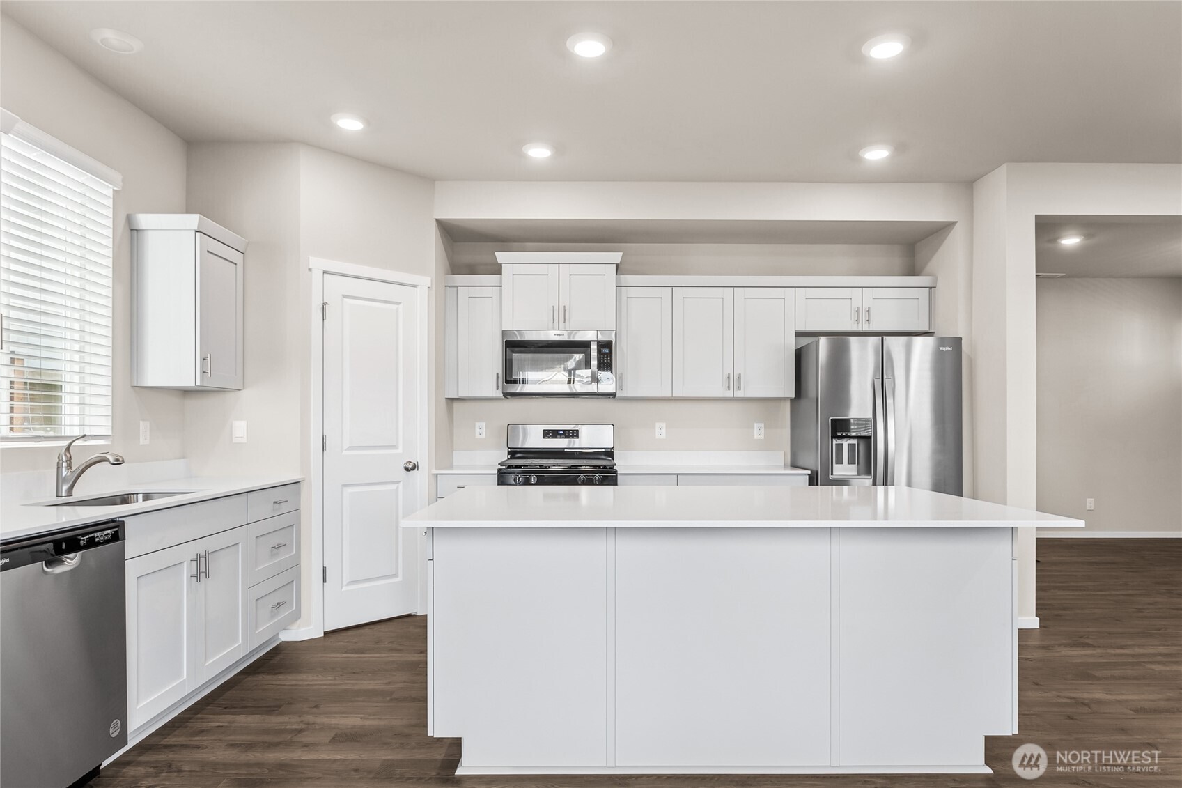 5801 Ivanoff Lane Southwest, Unit 68 Port Orchard, WA 98367 - Photo 10 of 25 a kitchen with stainless steel appliances granite countertop a sink and a refrigerator