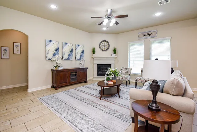 a living room with furniture and a fireplace