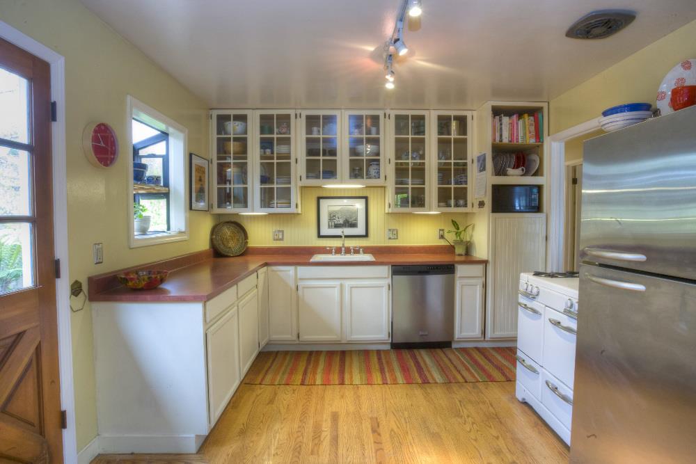 1452 Adobe Drive Pacifica, CA 94044 - Photo 9 of 23 a kitchen with a sink stove and cabinets